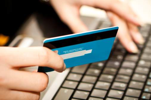 Online shopping with credit card on laptop